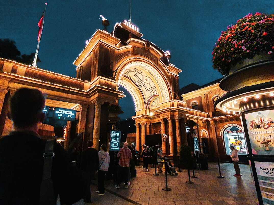 Families waiting in line at the entrance gates of Tivoli Gardens in Copenhagen